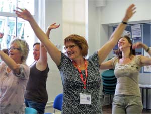 Teachers dance to Sandra Agard's creative writing session